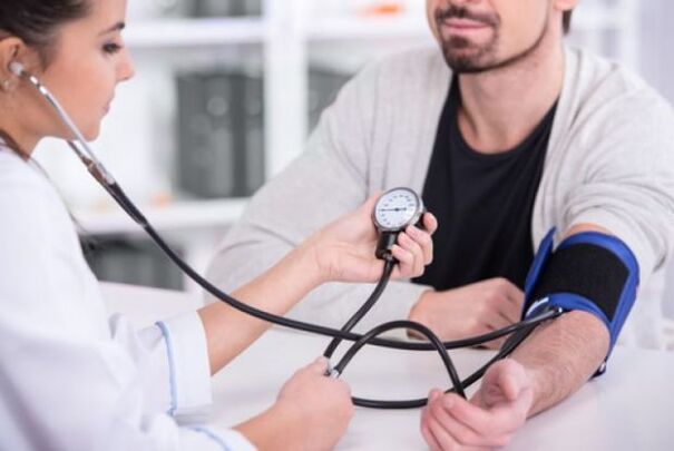 The doctor measures blood pressure in hypertension